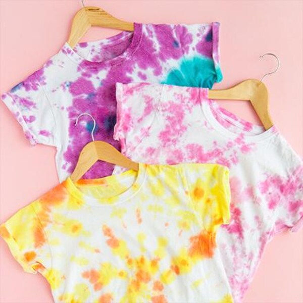 three tie-dyed t-shirts on hangers